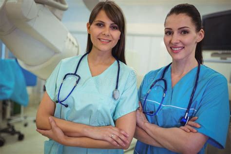 Portrait Of Two Female Nurse Standing With Arms Crossed Stock Image