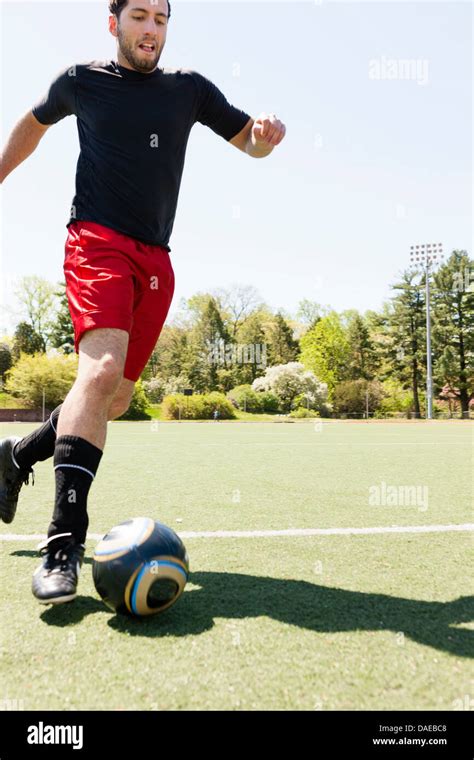 Soccer Player Running And Dribbling Ball Stock Photo Alamy