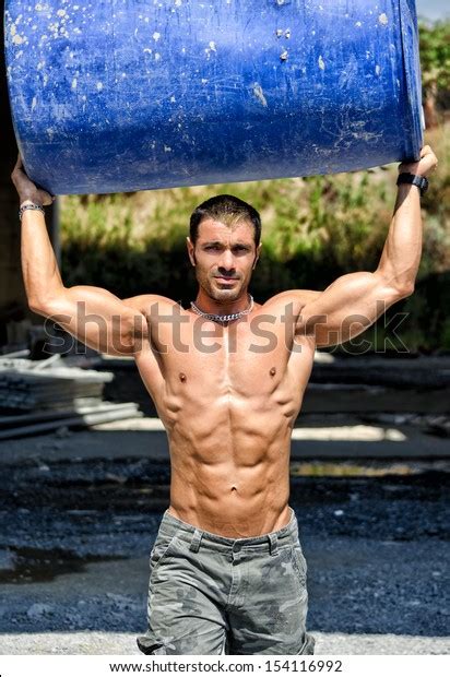 Hot Shirtless Muscular Construction Worker Carrying Stock Photo