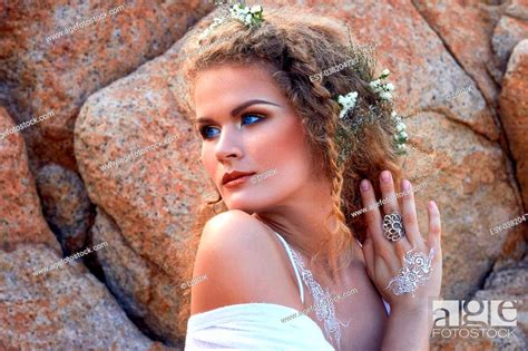 Portrait Of Pretty Sensual Curly Girl With Flowers In Her Head White Dress And Blue Eyes Stock
