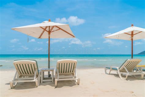 Beautiful Beach Chairs With Umbrella On Tropical White Sand Beach Stock