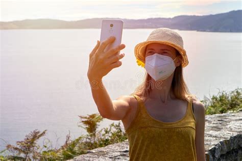 Young Woman In Protective Face Mask Making Selfie With Smartphone In A Lookout Point Stock Image