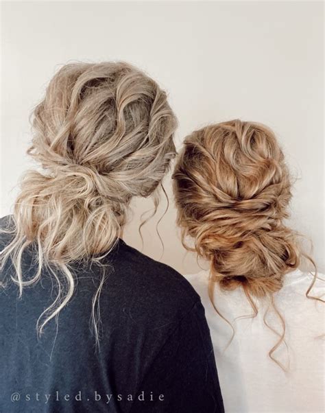 Two Women Standing Next To Each Other With Their Hair In Buns And Braids