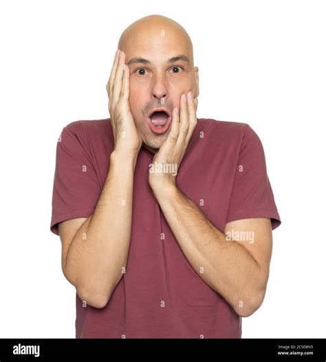 Shocked 40 Years Bald Man Holds His Head In Hands Isolated On White