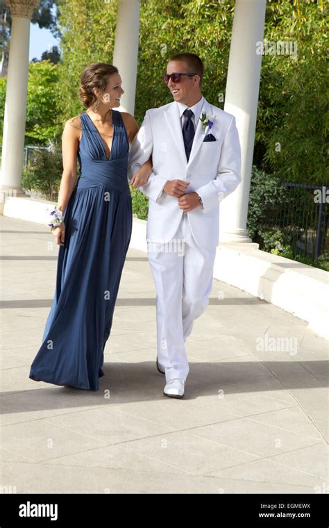 Attractive Teenage Prom Couple Walking In Dress And White Tuxedo