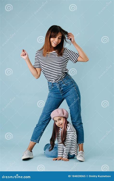 Two Fashion Lovers Mom And Daughter Wearing Same Clothes Over Blue