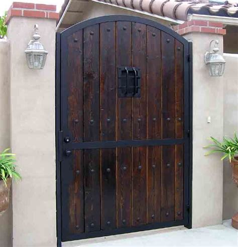 The deluxe decor gate hardware mounts on straight or angled walls using pivot points on the gate panels. Gates - Iron-Wood Gates | Wood gate, Rustic doors, House gate design