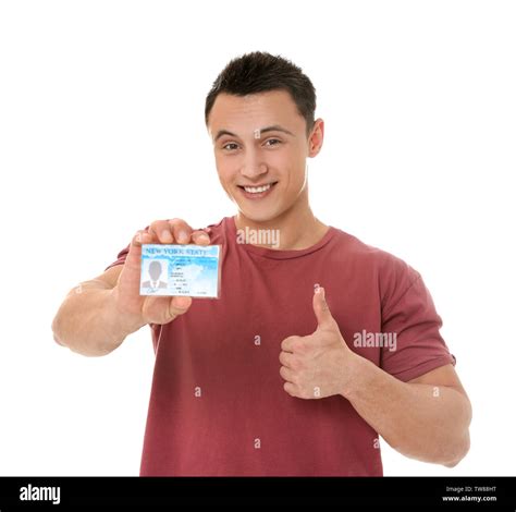 Young Man Holding Driving License On White Background Stock Photo Alamy