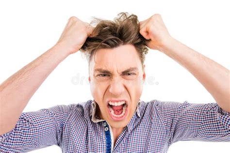 Close Up Portrait Of Young Man Screaming And Holding His Hair Stock