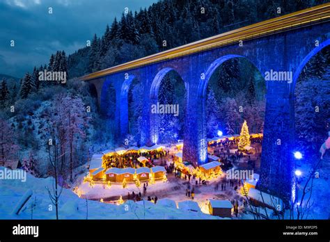 Snowy Christmas Market Under A Railway Viaduct Illuminated