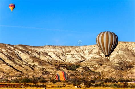 Hot Air Balloon Flying Over Valleys In Cappadocia Turkey Stock Photo