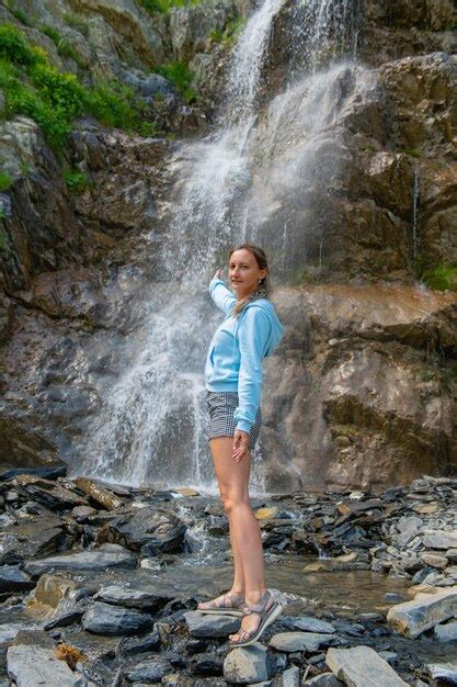 Premium Photo One Girl In Naked Clothes Stands At The Waterfall High