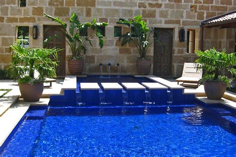 Learn about gunite pools, burton pools and spas. Modern pool and spa with vibrant blue glass tile finish ...