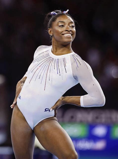 Simone Biles Poses In A Floral Swimsuit Showing Her Stunning Abs And Belly Piercing Photos