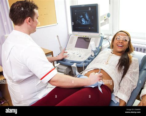A Young Pregnant Woman Undergoes An Ultrasound Scan Uk Stock Photo Alamy