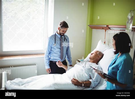 Doctor And Nurse Interacting With Patient Stock Photo Alamy