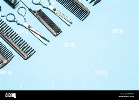Black Combs And Combs With Scissors On Blue Background Copy Space For