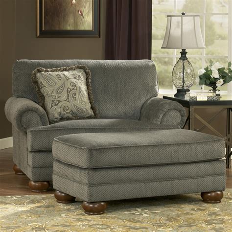 Transitional style is brought to life through its timeless rolled arms embellished with nailhead trim and soft pleats. Parcal Estates - Basil Chair and a Half and Ottoman by ...