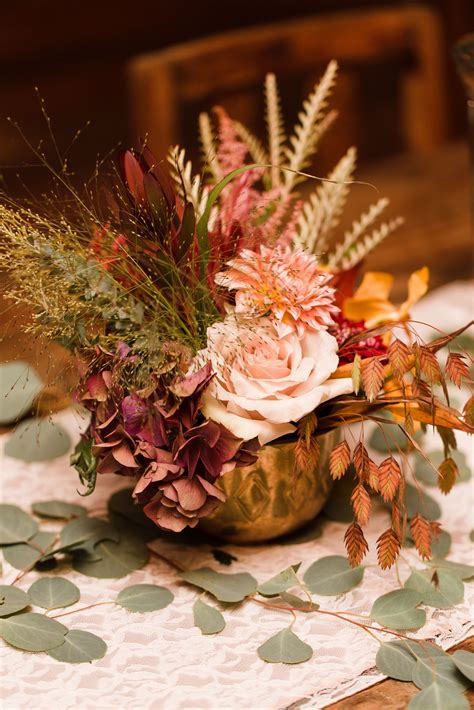 Fall Foliage And Flower Centerpiece In Gold Vase