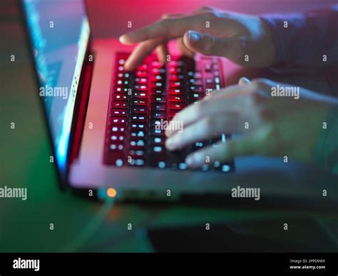 Hacker Typing On Illuminated Laptop Keyboard At Office Stock Photo Alamy