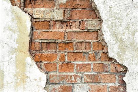 Old Red Brick Wall With White Damaged Plaster Background Stock