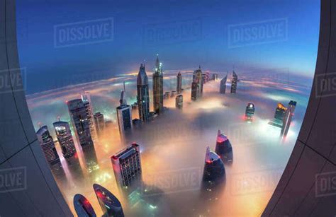 Aerial View Of Cityscape With Illuminated Skyscrapers Above The Clouds