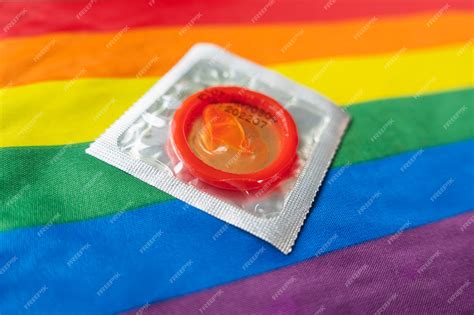 Premium Photo A Condom On A Multicolored Rainbow Flag Concept Of Safe Sex