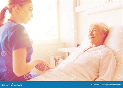 Doctor Or Nurse Visiting Senior Woman At Hospital Stock Image Image