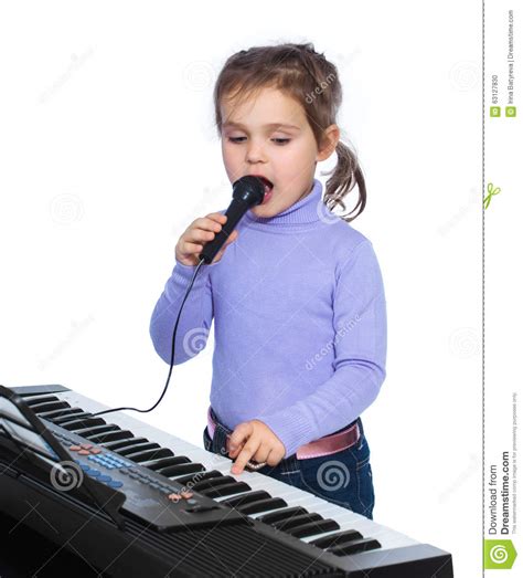 Portrait Of A Little Girl Sings And Plays The Piano Stock Photo Image