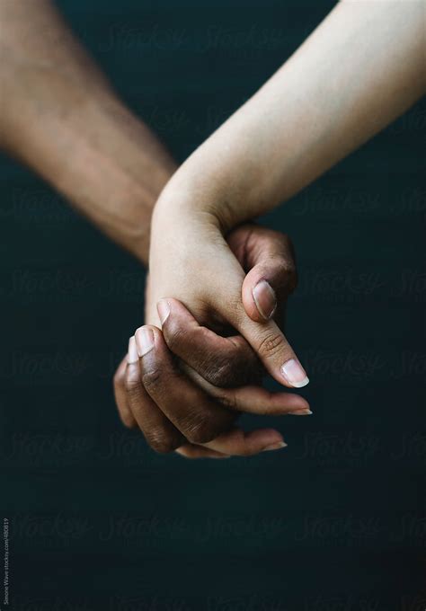Mixed Race Couple Holding Hands By Simon Hand Holding Stocksy United