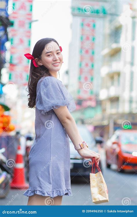 Asian Beautiful Girl In Chinese Dress Is Smiling And Walking On Street