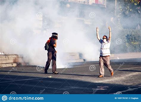 Protesters On The Street Covered With Tear Gas Fired By The Police