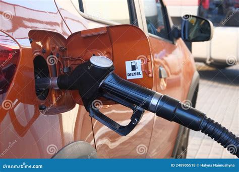 Car Fill With Diesel At Gas Station Pumping Diesel Fuel In Orange Car