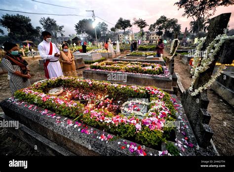 Christian family members pay respect and offer prays beside the grave