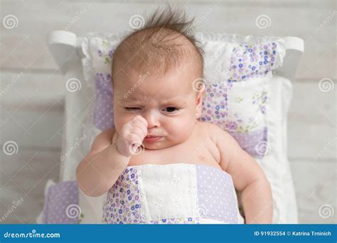 Pouting Baby Girl In Tiny Bed Stock Photo Image Of Facial Little