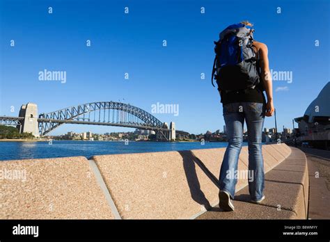 A Backpacker Walks Along The Sydney Harbour Waterfront Sydney New