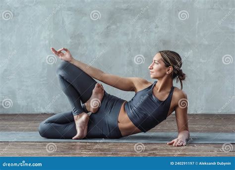 Young Athletic Woman Practicing Yoga Lying On The Floor In A Relaxed