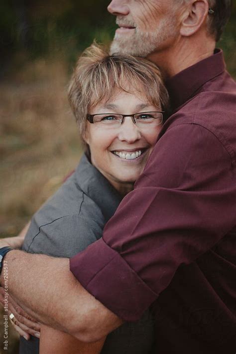 Middle Aged Woman Enjoying A Hug From Her Husband By Stocksy Contributor Rob And Julia