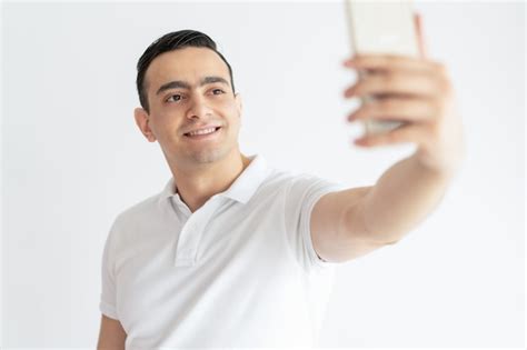 Free Photo Smiling Young Guy Taking Selfie Photo On Smartphone