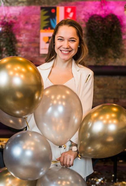 Free Photo Smiling Attractive Woman Holding Silver Balloons In Party