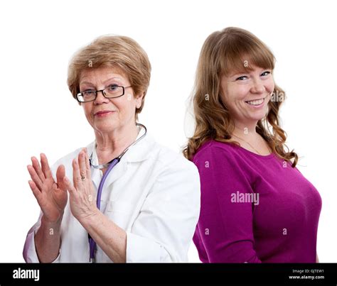 Happy Gesturing Doctor And Laughing Female Patient Behind Looking At