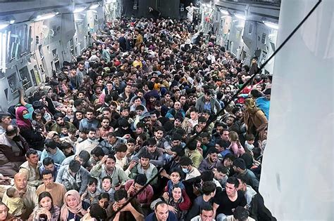 over 600 afghans cram into cargo plane in flight from kabul abs cbn news