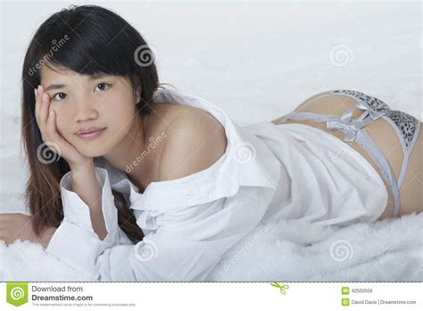 Asian Woman Wearing A White Shirt On White Backround Stock Photo