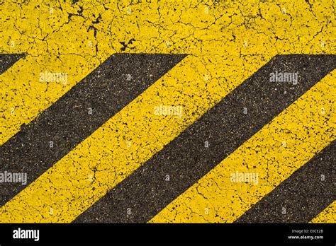 Yellow Striped Road Markings On Black Asphalt Highway No Parking Is