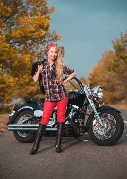 Beautiful Biker Woman Posing With Motorcycle On The Road Stock Image