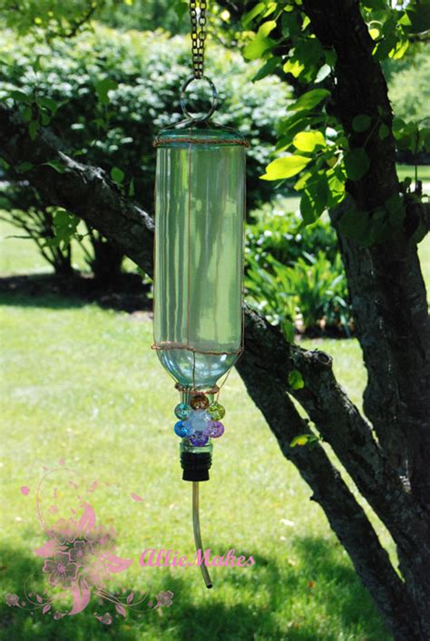 Cut a small x into the center of the flower with a craft knife and push the neck of the bottle through. What Allie's Making Now: Wine Bottle Hummingbird Feeder