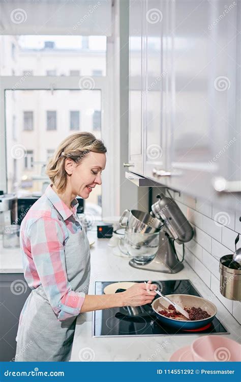 Cheerful Housewife Cooking Dish Stock Photo Image Of Female Blond
