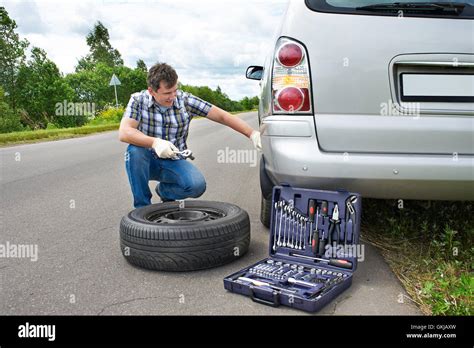 Man Changing A Wheel Of Car On Road Stock Photo Alamy