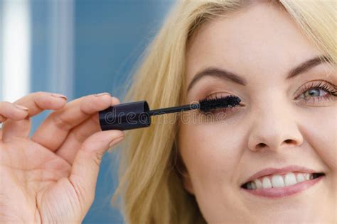 Woman Using Mascara On Her Eyelashes Stock Photo Image Of Makeup