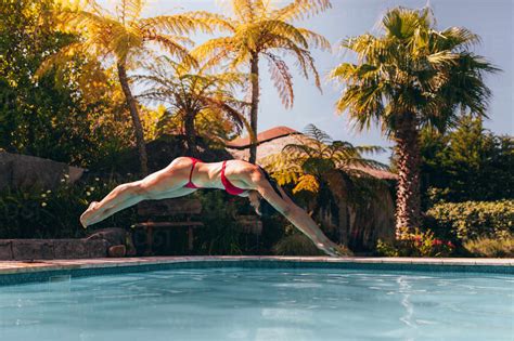 Frau Im Badeanzug Springt In Den Pool Mädchen Im Bikini Taucht In Einen Pool Lizenzfreies